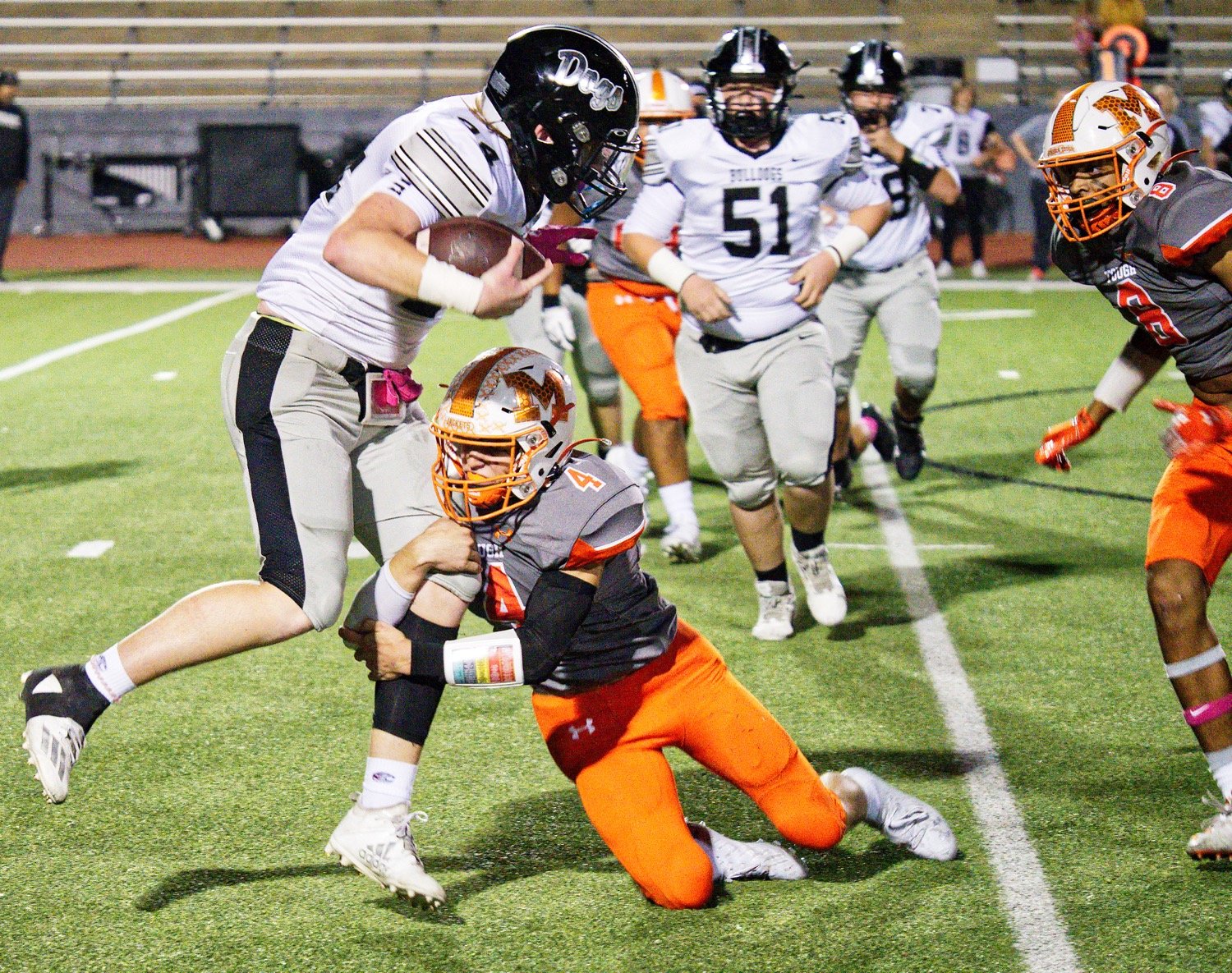 Coy Anderson wraps up the Howe ball carrier Oct. 22 at homecoming.